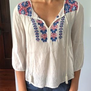 White summer top with red and blue front.
